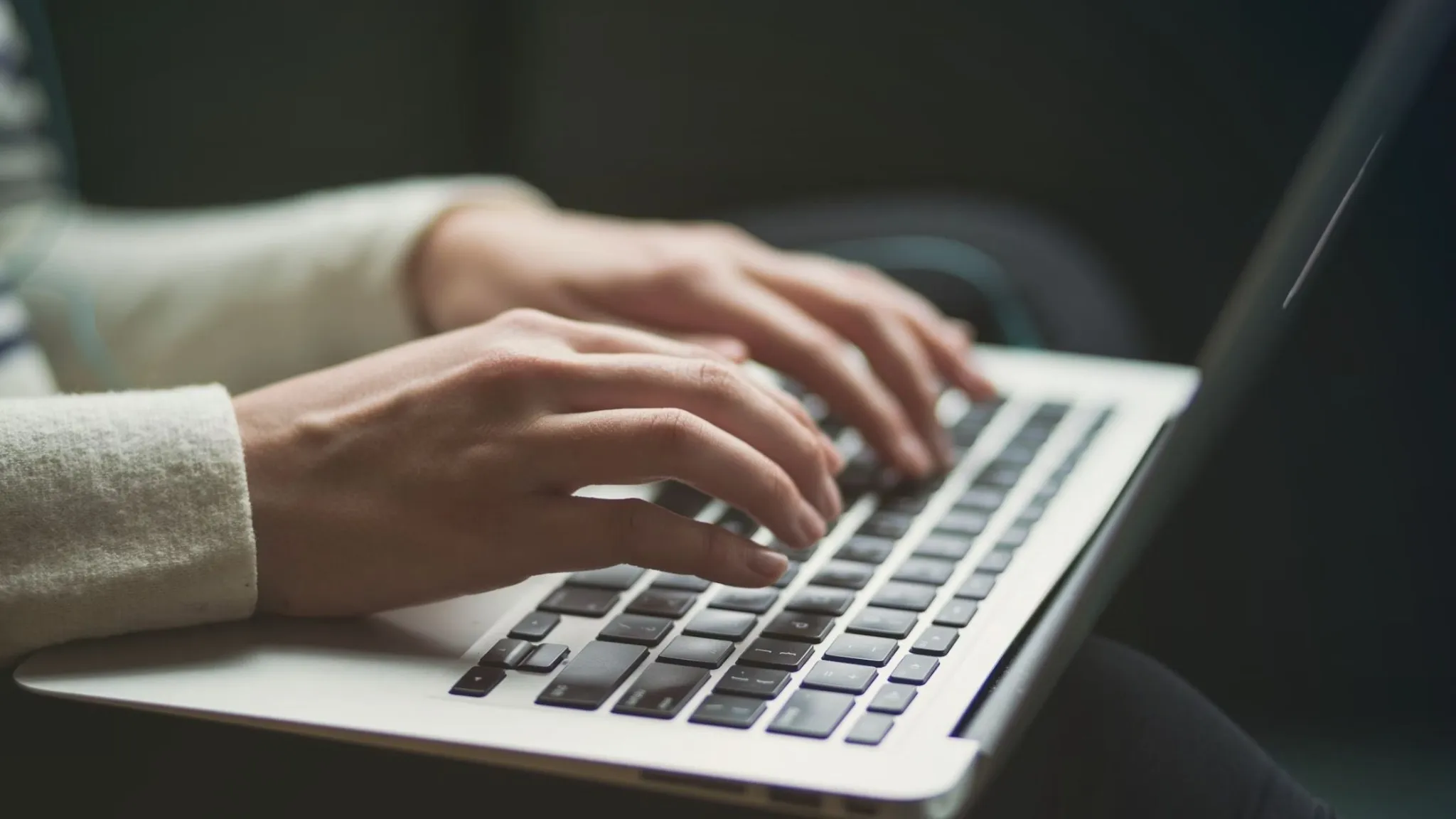 A person typing on a laptop 